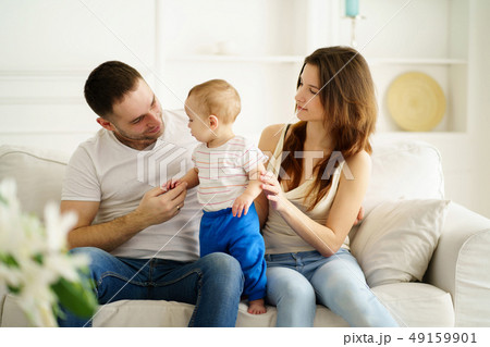 mother, father and little son in living room mother, father and little son in living room 49159901