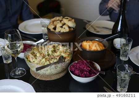 table set, salads, glasses and bottle of wine table set, salads, glasses and bottle of wine 49160211