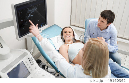 Doctor on consultation with pregnant woman and her husband. 49160362