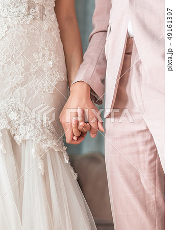 Married couple bride and groom holding hands Married couple bride and groom holding hands 49161397