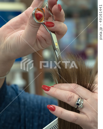 The technique of cutting hair with scissors. The technique of cutting hair with scissors. 49161441