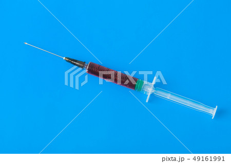 Medical syringe on blue Medical syringe on blue 49161991