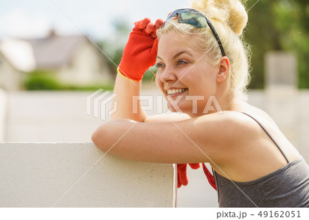 Woman taking break on construction site Woman taking break on construction site 49162051