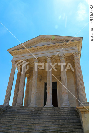 Facade of antique Roman temple over blue sky Facade of antique Roman temple over blue sky 49162532