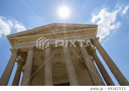 Facade of antique Roman temple over blue sky Facade of antique Roman temple over blue sky 49162533