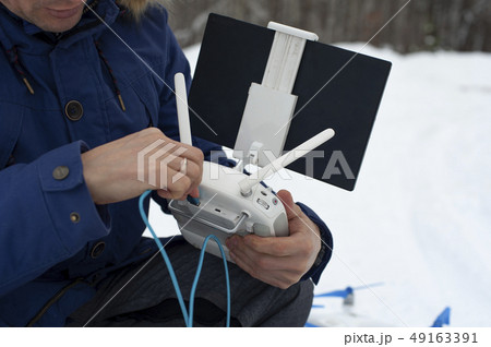 Video operator preparing for Drone flying in winter Video operator preparing for Drone flying in winter 49163391