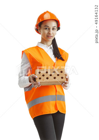 The female builder in orange helmet isolated on white The female builder in orange helmet isolated on white 49164132