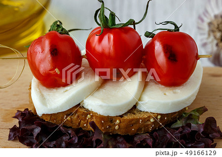 Bruschetta with mozzarella and cherry tomatoes 49166129
