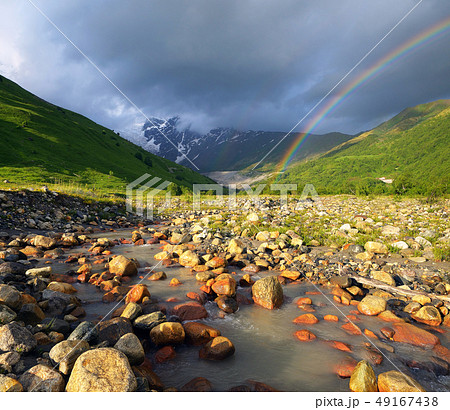Rainbow in the mountains above the river Rainbow in the mountains above the river 49167438