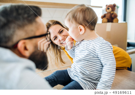 A portrait of young family with a toddler girl moving in new home. 49169611