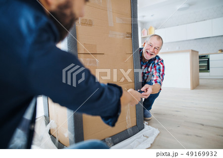 A senior man helping his son with furnishing new house, a new home concept. 49169932