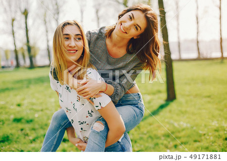 two girls in a summer park two girls in a summer park 49171881