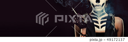 Woman with skeleton face art smoking Woman with skeleton face art smoking 49172137