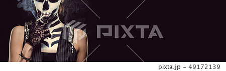 Woman with skeleton face art smoking over black Woman with skeleton face art smoking over black 49172139