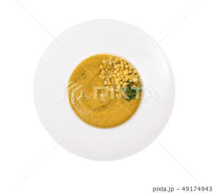 White plate with corn mash soup 49174943