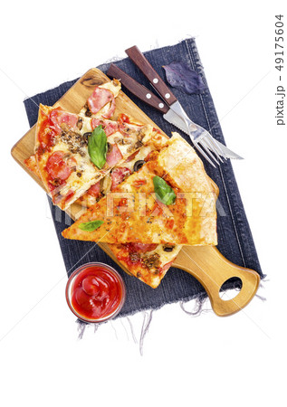 Slices of pizza on wooden board on jeans. 49175604