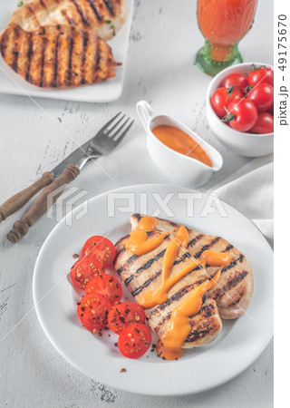 Grilled chicken breast with sauce and cherry Grilled chicken breast with sauce and cherry 49175670