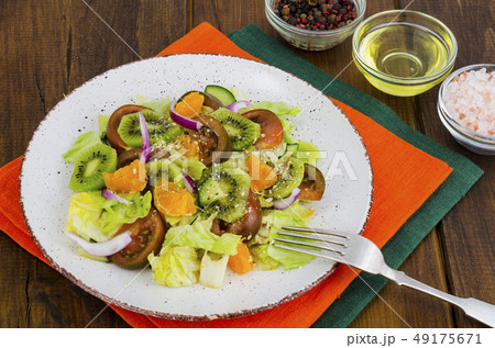 Fruit and vegetable salad with tangerines. 49175671