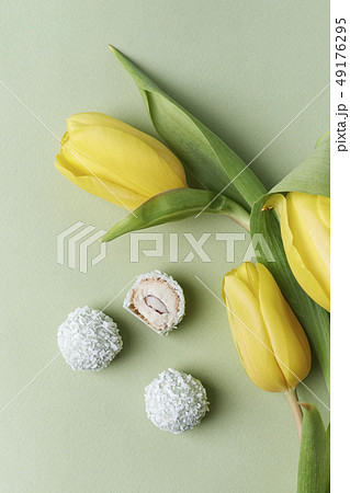 coconut candies and yellow tulips 49176295