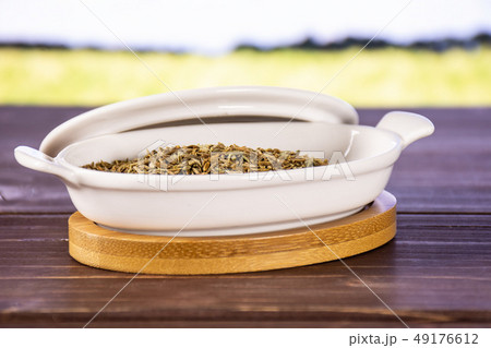 Roman caraway cumin with field behind 49176612
