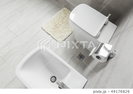 White ceramic bidet and toilet at luxury bathroom White ceramic bidet and toilet at luxury bathroom 49176826