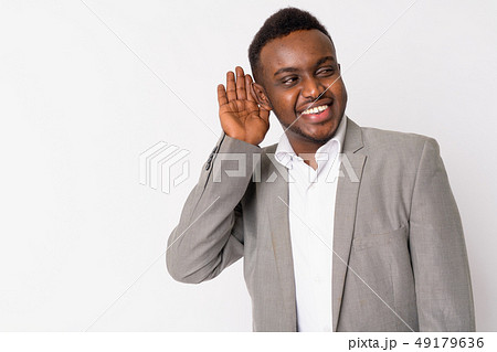 Portrait of happy young African businessman thinking and listening 49179636