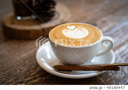cappuccino with latte art on wooden background. 49180447