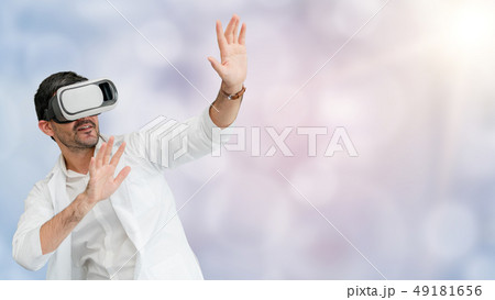 Doctor wearing VR virtual reality goggles. Doctor wearing VR virtual reality goggles. 49181656