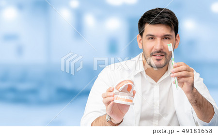 Dentist with toothbrush, focus at toothbrush. 49181658