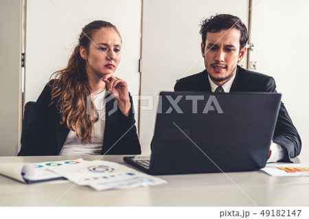 Unhappy serious businessman and businesswoman. Unhappy serious businessman and businesswoman. 49182147