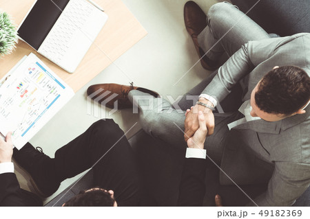 Businessmen handshake business deal in office. 49182369