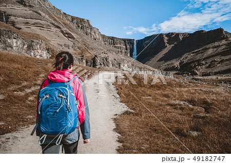 Traveler hiking at Hengifoss Waterfall, Iceland. Traveler hiking at Hengifoss Waterfall, Iceland. 49182747