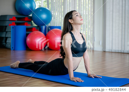 Young woman practice yoga in an gym studio. 49182844