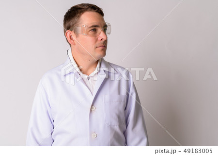 Portrait of handsome man doctor with protective glasses thinking 49183005