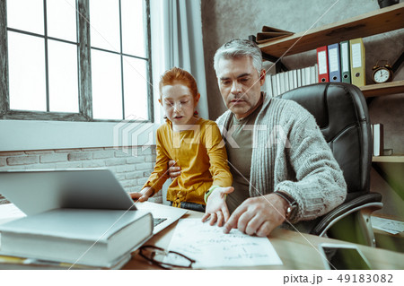 Serious nice man sitting with his daughter Serious nice man sitting with his daughter 49183082