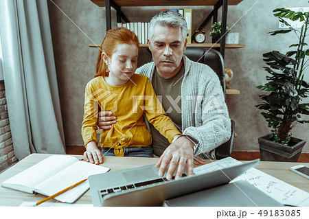 Serious nice man pressing the button on his laptop 49183085