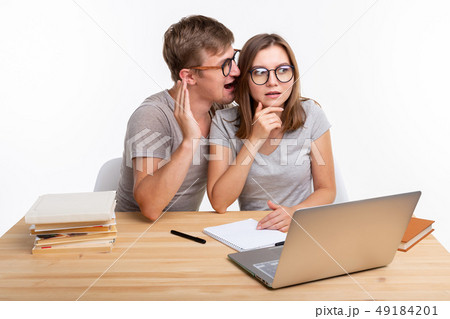 People and education concept - couple of students whispering 49184201