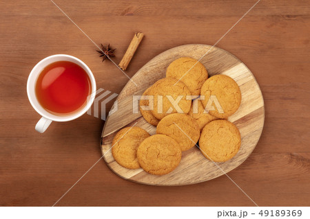 Gingersnaps, shot from the top with a cinnamon stick, an anise star, a cup of tea, and a place for Gingersnaps, shot from the top with a cinnamon stick, an anise star, a cup of tea, and a place for 49189369