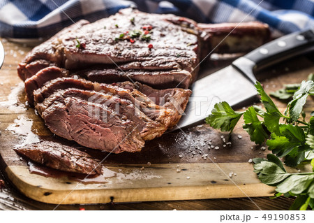 Freshly grilled tomahawk steak on slate plate with 49190853