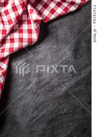 Top of view red checkered tablecloth on black Top of view red checkered tablecloth on black 49191411