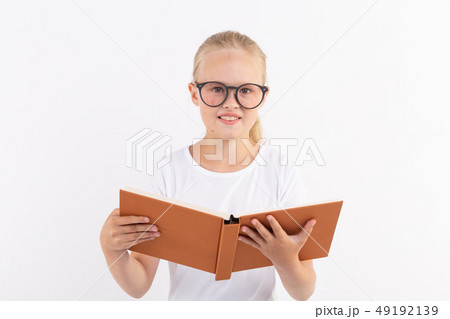 education, people, children and school concept - School student in goggles holding book in hands on 49192139