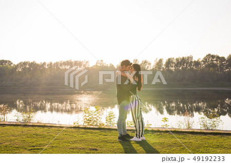 Tenderness, love and nature concept - Beautiful woman and handsome man hugging over water background 49192233