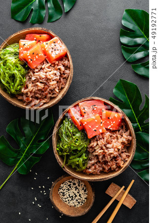 Poke bowl with raw salmon fish, chuka salad Poke bowl with raw salmon fish, chuka salad 49192771