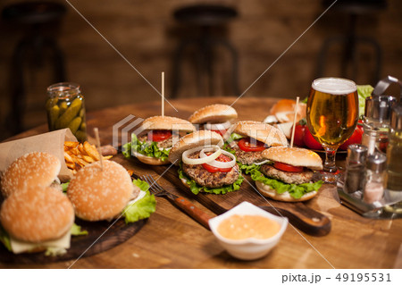 Lots of delicious burgers lying on a table 49195531