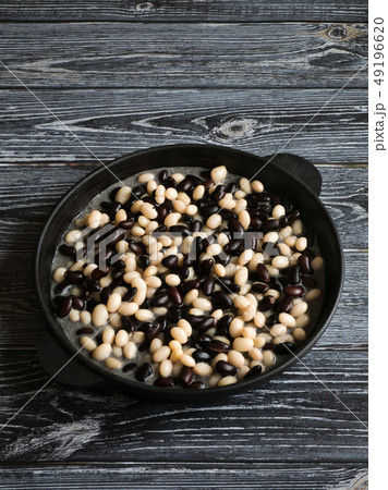 Black and white baked beans in a pan. Black and white baked beans in a pan. 49196620