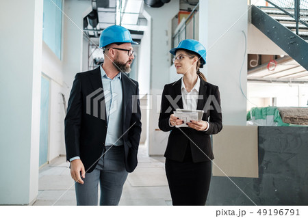 Engineers in hardhats have conversation Engineers in hardhats have conversation 49196791