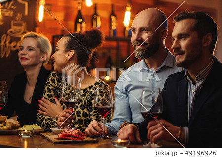Group of friends having fun talk behind bar counter in a cafe 49196926