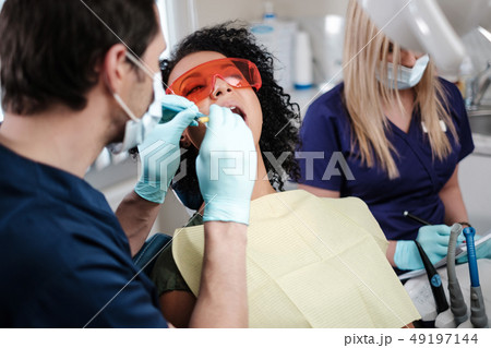 Dentist and his assitant working in private practice. 49197144