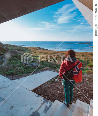 Andoya island and tourist with norwegian flag Andoya island and tourist with norwegian flag 49198816