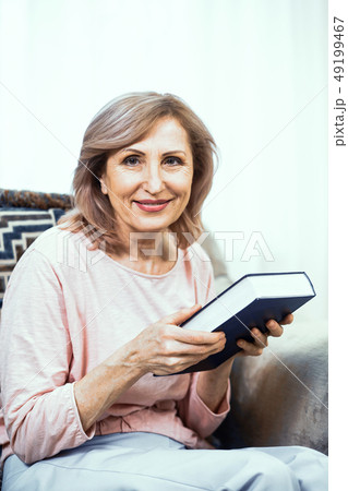 Elderly Woman With a Thick Blue Book in Her Hands. Elderly Woman With a Thick Blue Book in Her Hands. 49199467